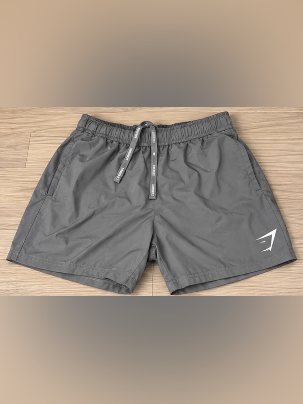 Gymshark men’s gray athletic performance shorts, size Medium.